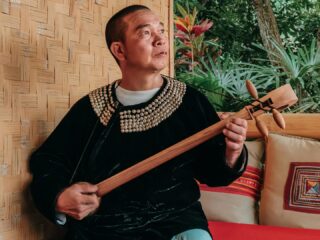 1726558758 A Lisu man playing the traditional reed pipe
