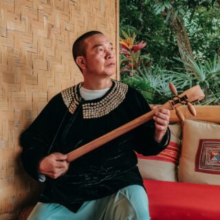 1726558758 A Lisu man playing the traditional reed pipe